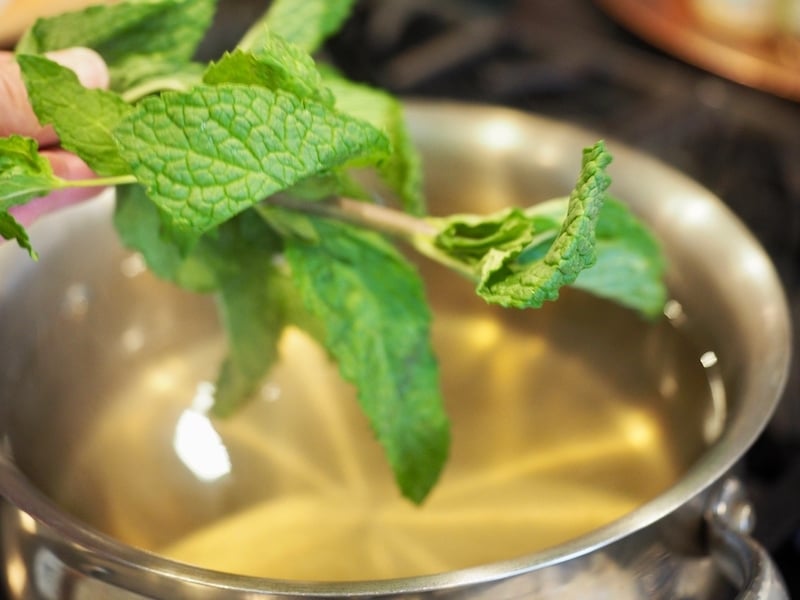 Adding fresh mint to simple syrup for Texas Tea.