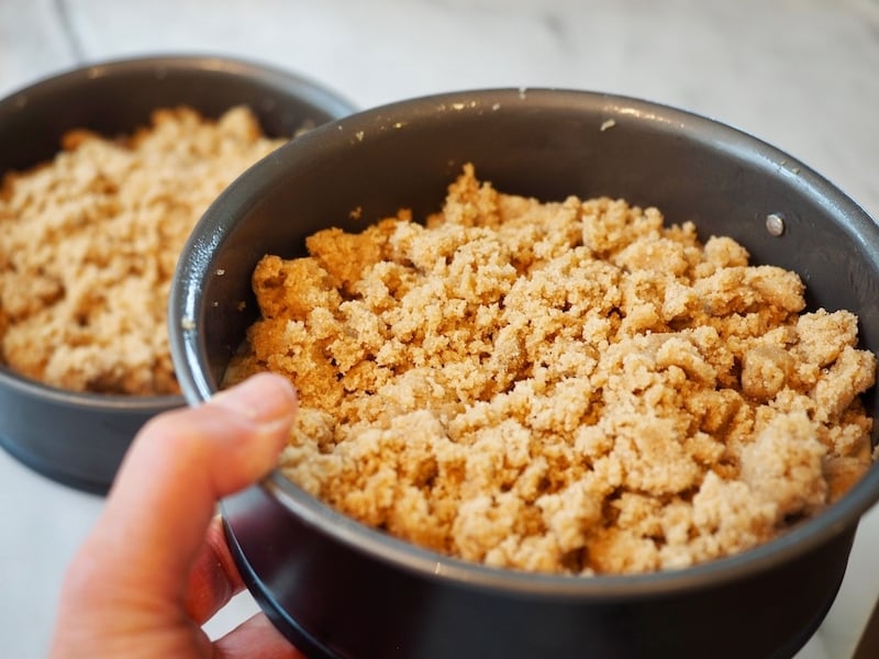 Holding two smaller Blueberry Crumble Cakes in 6" springform pans 