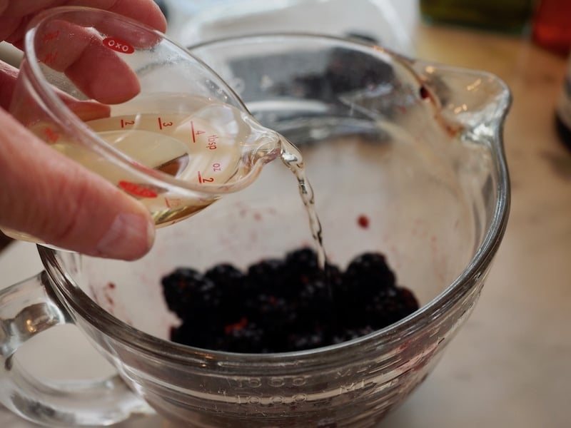 Pouring vinegar in small bowl for Blackberry Grilled Chicken Salad |