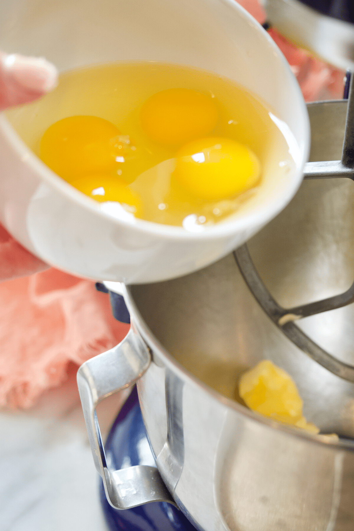 Adding room temp eggs to pound cake batter.