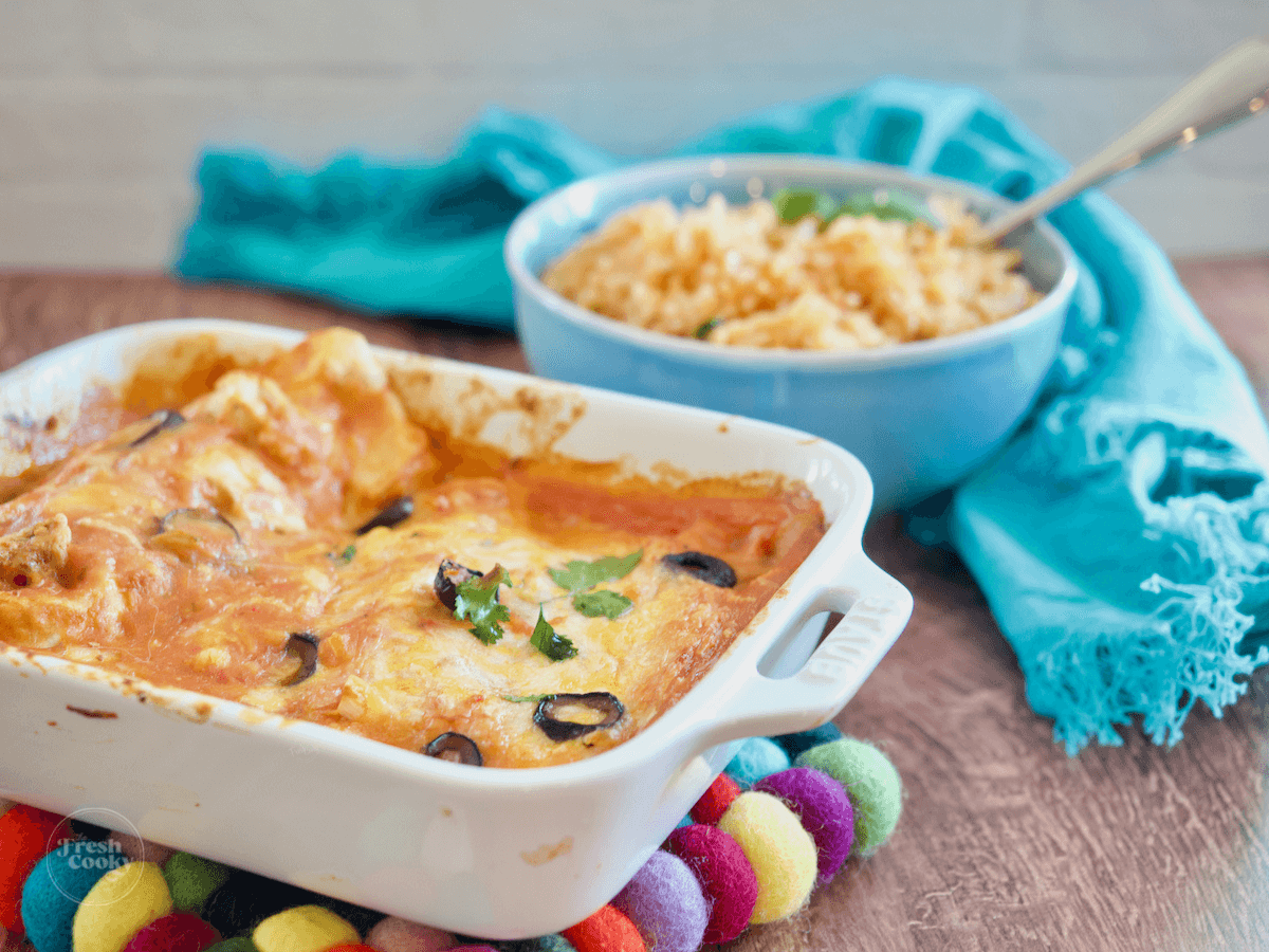 Spanish rice vegetarian along with a casserole of enchiladas.