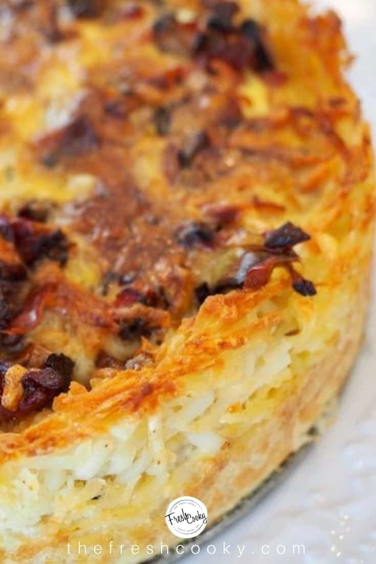 A close-up shot of the prosciutto quiche with hashbrown crust on a white plate.