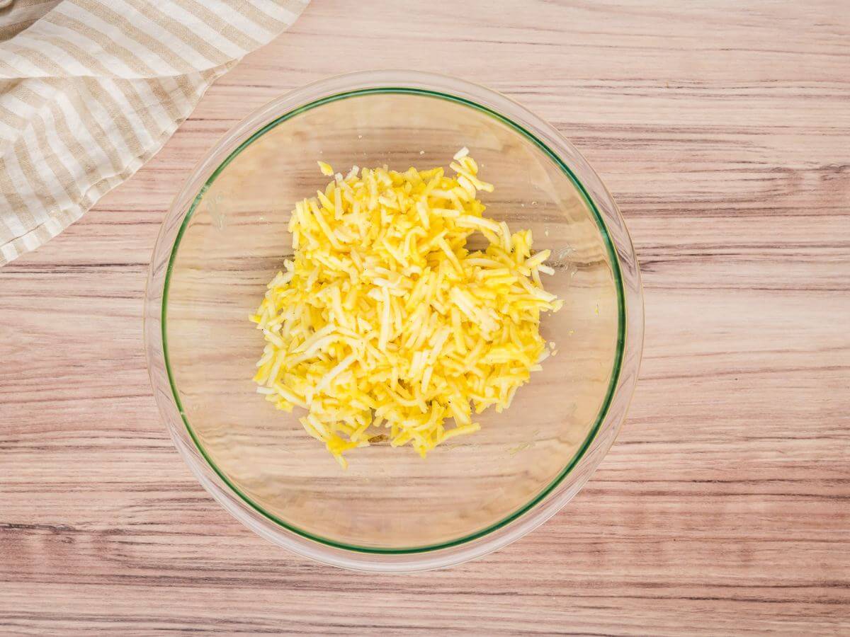 Hash brown crust mixture in bowl. 