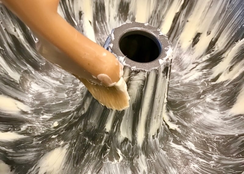 Buttering with pastry brush a bundt pan. 