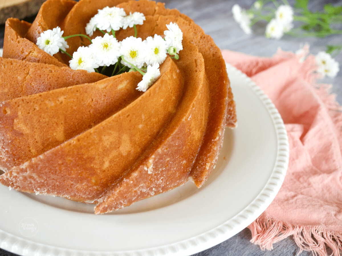 Beautiful kentucky butter cake on a platter with edible flowers on top.