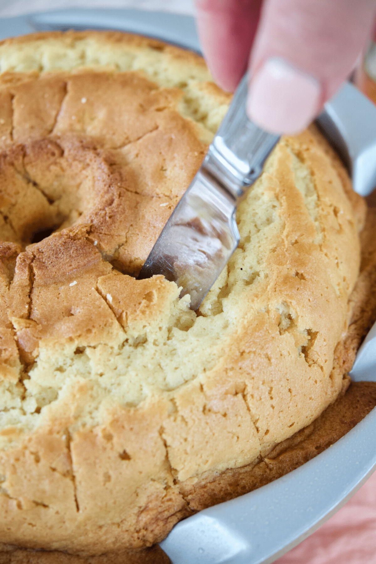 Using a thick knife or chopstick, poke holes in warm cake. 