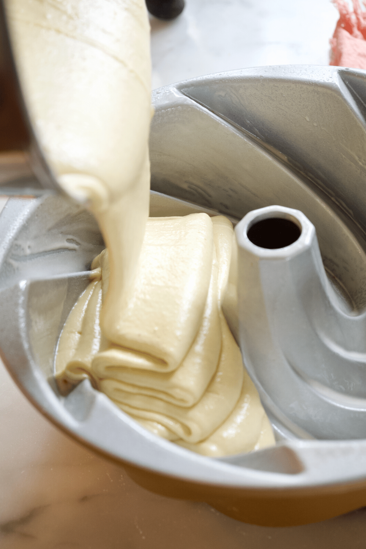 Pour pound cake butter batter into prepared bundt pan. 