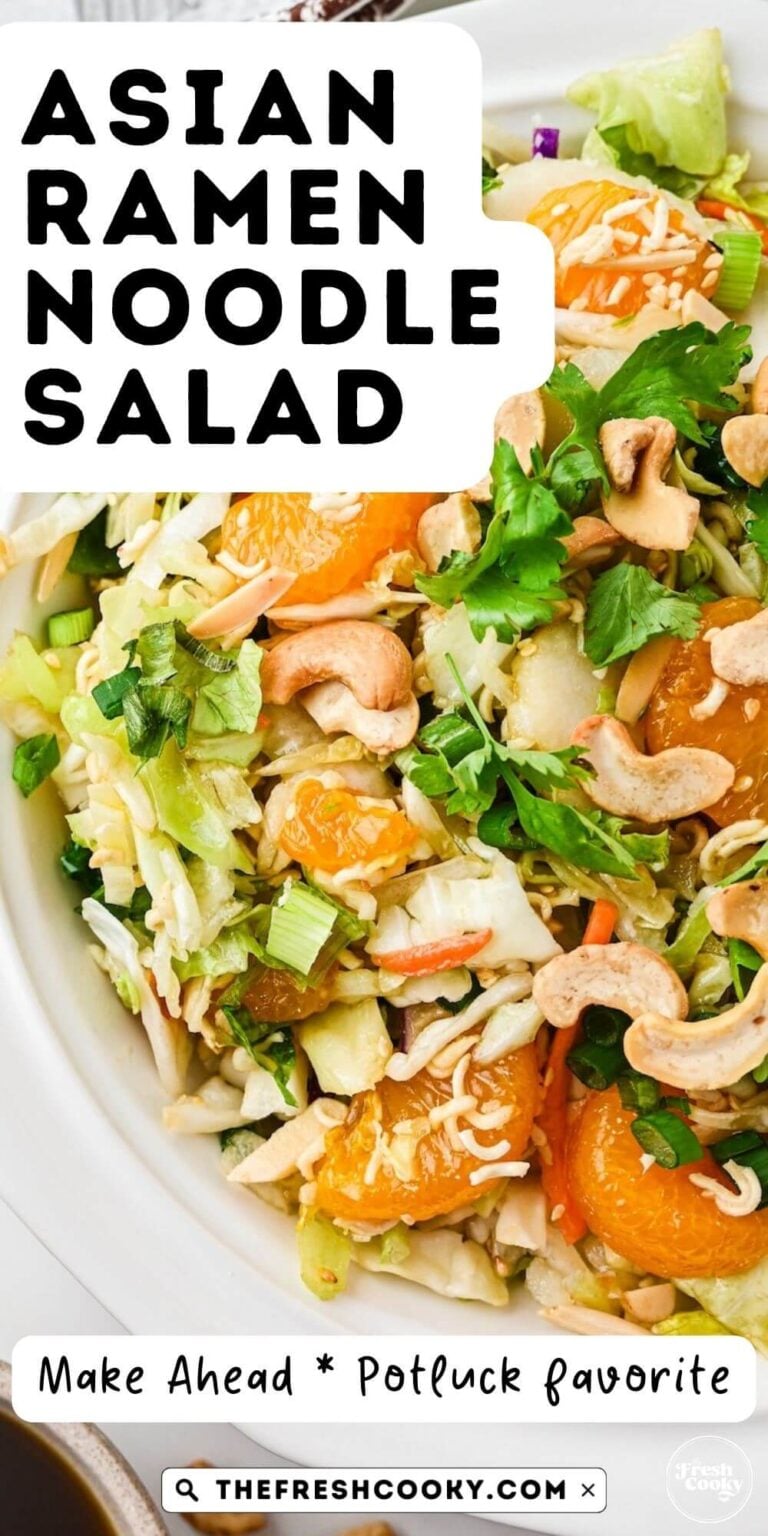 A Ramen Noodle Salad in a pretty white bowl, topped with mandarin oranges, cilantro, cashews, crunchies for pinning.
