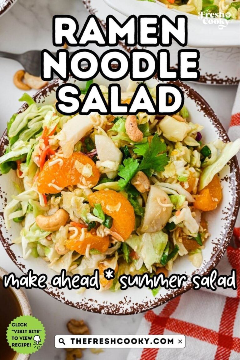 A pretty rustic bowl filled with a bright green cabbage salad with ramen noodles, almonds, oranges tossed in an Asian dressing, for pinning.