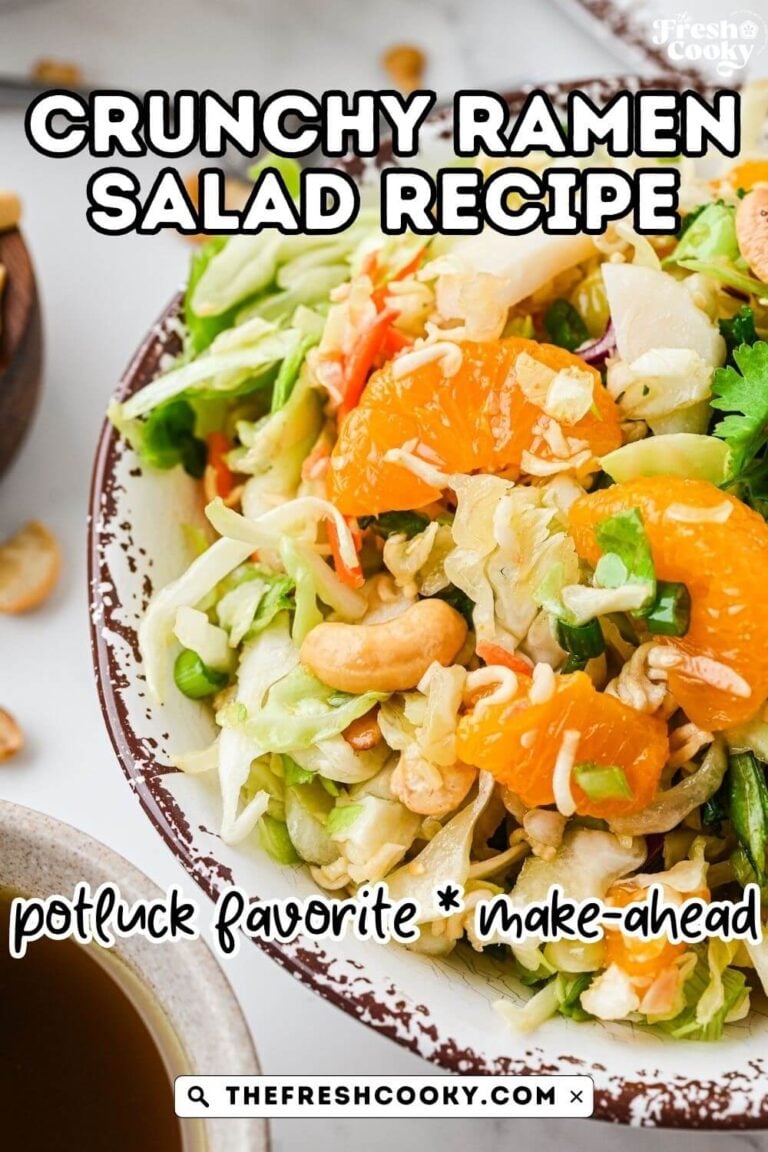 Close up of a rustic bowl of ramen noodle salad made with cabbage and tossed with oranges, green onions, cashews, almonds and other crunchies, to pin.
