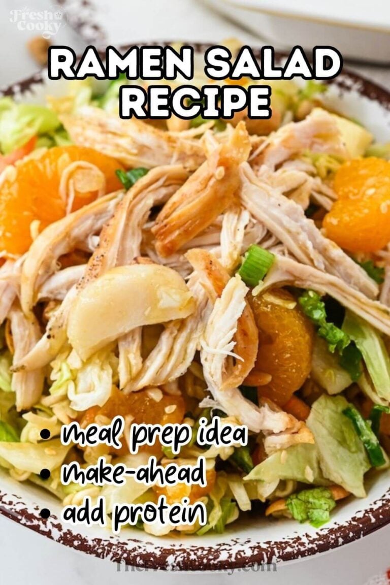 Ramen Noodle Salad in a pretty bowl, garnished with shredded chicken, mandarin oranges, cilantro, cashews and tossed in an Asian dressing, to pin.