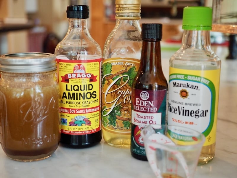 dressing ingredients for Asian Ramen salad; Bragg's Liquid aminos, grapeseed oil, toasted sesame oil, rice vinegar for Asian Noodle Salad from thefreshcooky.com