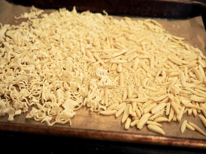 Toasting ramen noodles and slivered almonds.