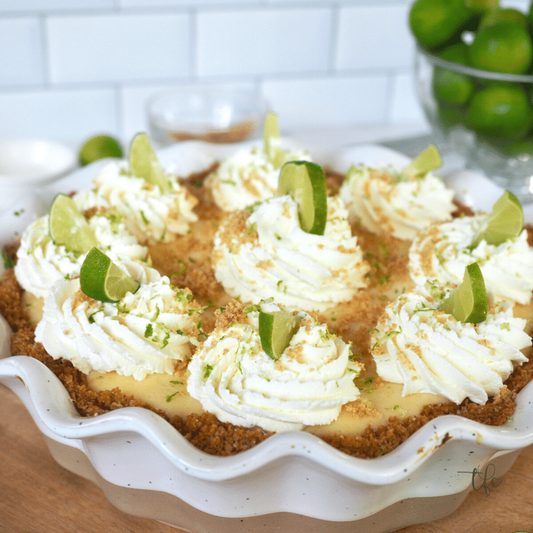 Whole Key Lime pie with swirls of whipped cream. 