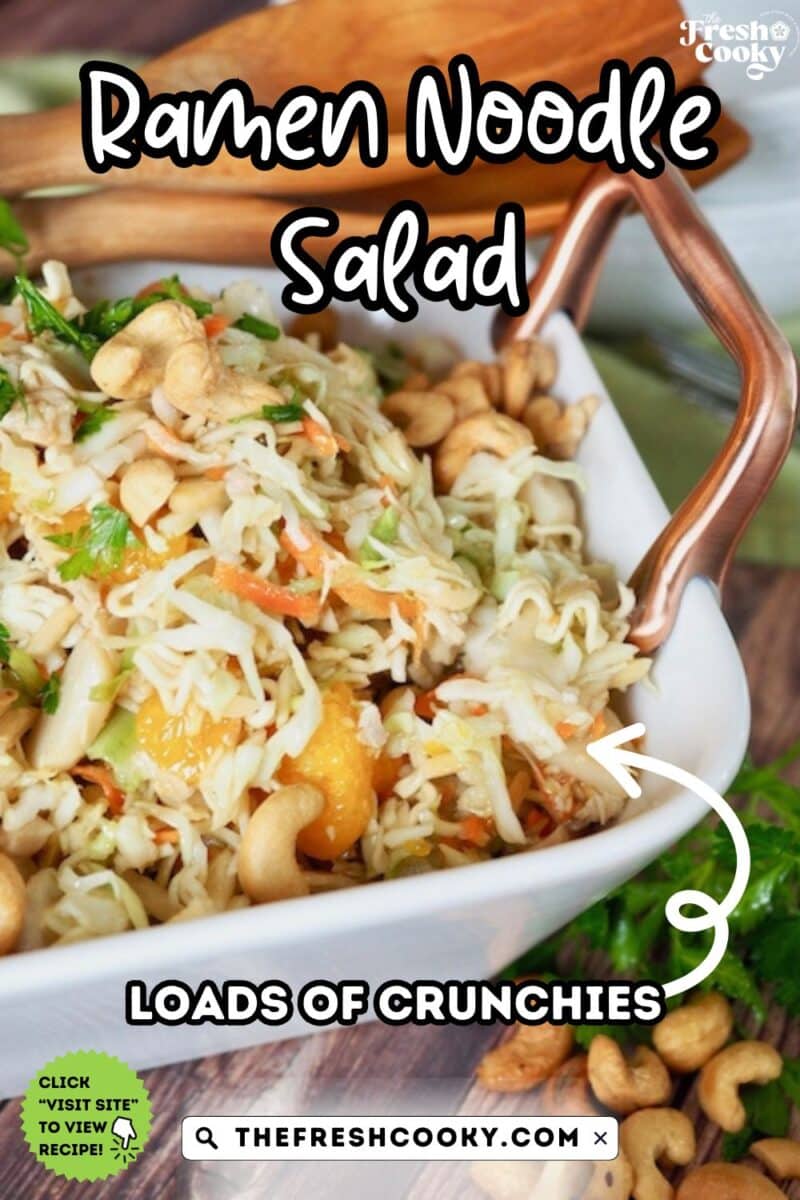 A bowl of ramen noodle salad with mandarin oranges, nuts, seeds, in a flavorful asian dressing.