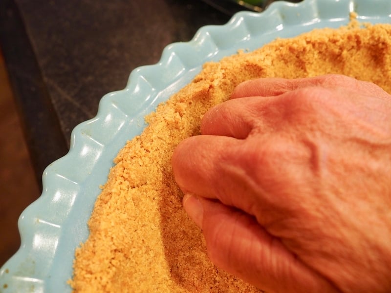 Graham Cracker Crust pressing with knuckles for crust for Easy Key Lime Pie.