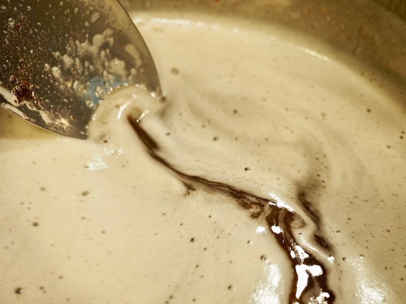 a spoon swirling browning butter in a pan. 