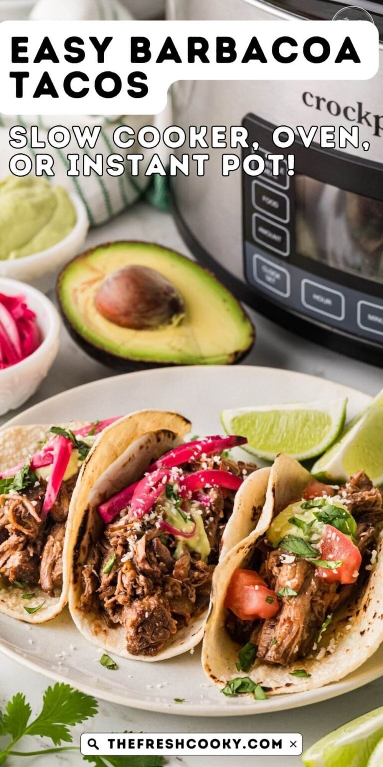 A plate in front of a crockpot with three barbacoa beef tacos, surrounded by avocado, red onions and avocado crema.