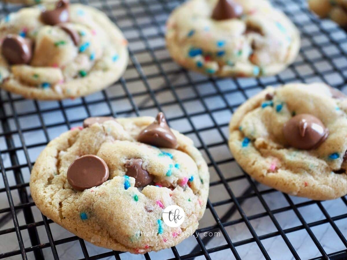 Cake batter chocolate chip cookies on a wire cooling rack.