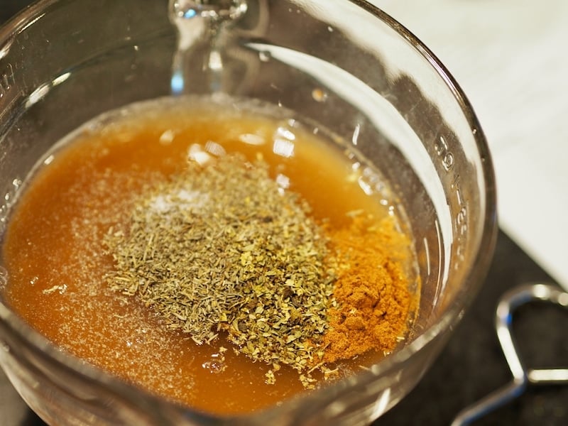 Seasonings and broth for Barbacoa meat in mixing bowl | www.thefreshcooky.com