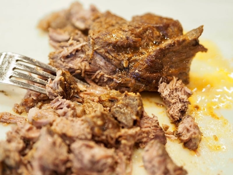 Shredding Barbacoa Beef with fork.