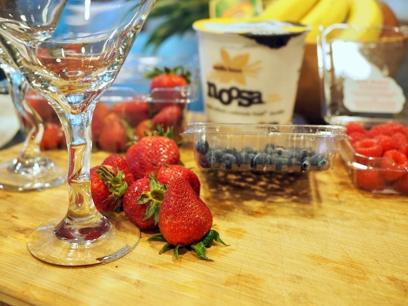 Ingredients for red, white and blue yogurt parfaits. L-R Strawberries, blueberries, raspberries and vanilla Noosa yogurt.