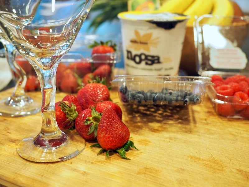 Ingredients for red, white and blue yogurt parfaits. L-R Strawberries, blueberries, raspberries and vanilla Noosa yogurt. 