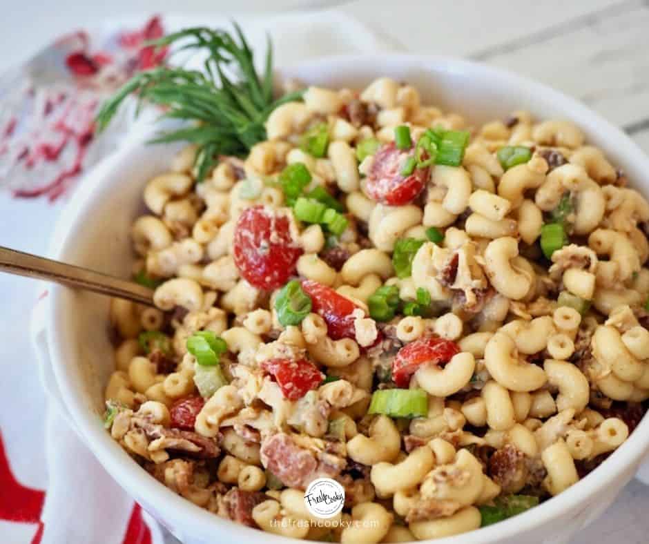 white porcelain bowl of bacon balsamic macaroni salad with red tomatoes, green onions and crisp celery and bacon | thefreshcooky.com