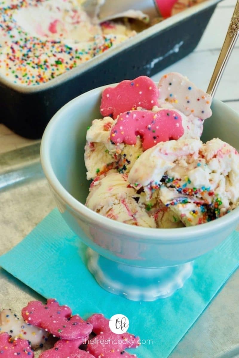 Circus Animal Ice Cream no churn in a pretty turquoise boil with extra Circus Animal Cookies laying about.