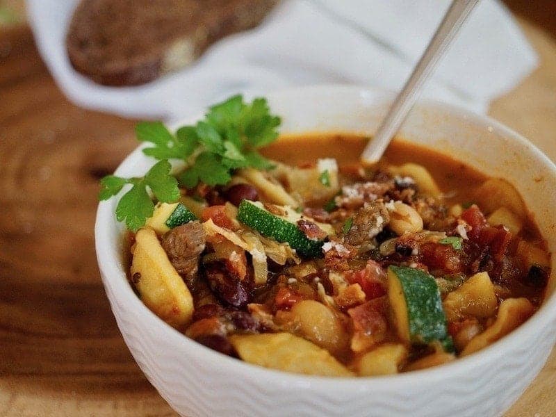 Warm up with this hearty minestrone soup with smokey bacon and tender beef bits! This classic Italian soup recipe is easy to make and tastes amazing. #thefreshcooky #soup #healthyrecipe #bacon #beef #minestrone