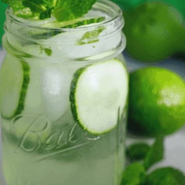Spa water for adults! This 21+ Cucumber Cooler is so light, crisp and refreshing, filled with crunchy cucumbers, and the option of refreshing mint or earthy basil. Enjoy it after a hot afternoon playing outside or sipping with your girlfriends. #thefreshcooky #cucumbercooler #cocktail #mocktail #ginandtonic #mint #basil #lime