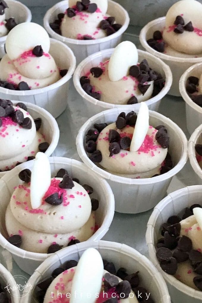 Cookie dough Frosting shooters in individual cups with pink sprinkles and mini chocolate chips.