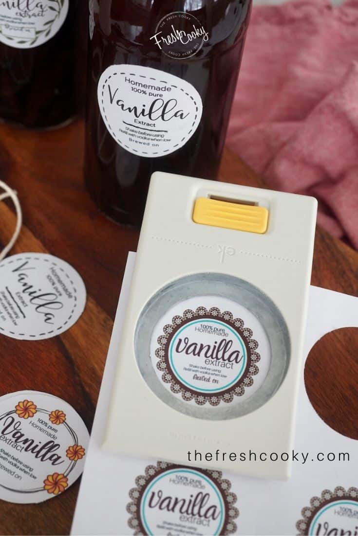 sheets of vanilla labels with a 2" punch punching out the label.