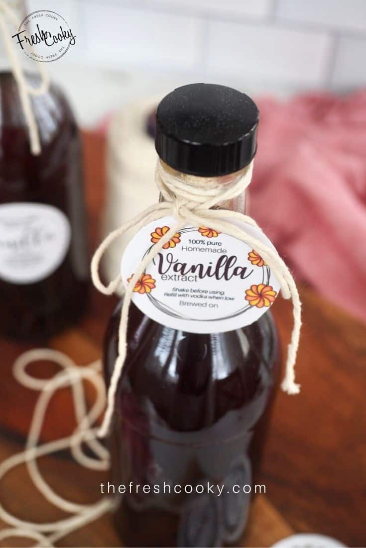 Small bottle of vanilla extract tied with twine and a round label saying Vanilla Extract tied on.