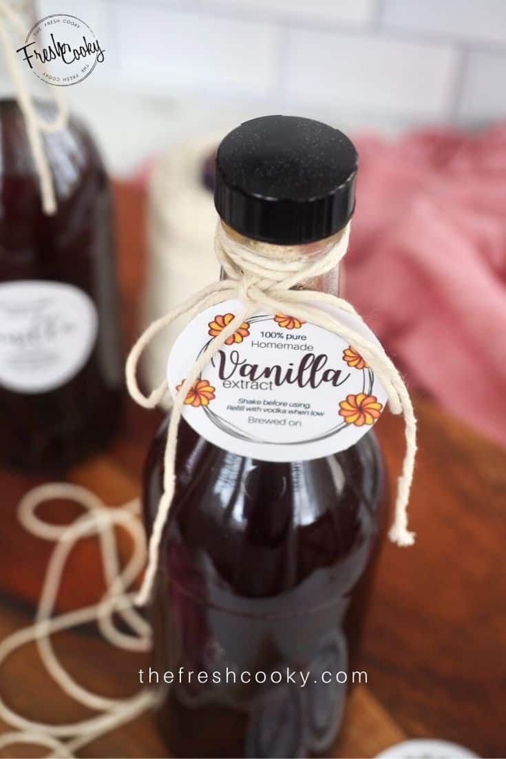 Small bottle of vanilla extract tied with twine and a round label saying Vanilla Extract tied on. 