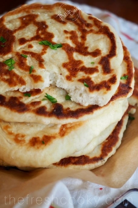 This recipe for restaurant style, homemade Naan bread is like bringing a taste of India into your kitchen. Learn how to make this simple flatbread with my step by step instructions. #thefreshcooky #naan #bread #indianfoods #authentictaste #restaurantstyle #butterchicken #curry