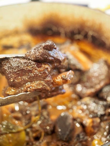 Return ribs to the pot, snuggling into the juices.