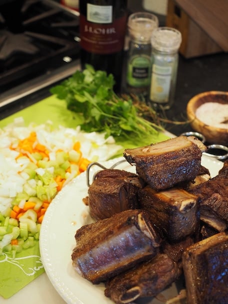 browned short ribs on plate with chopped veggies and other ingredients ready to assemble.