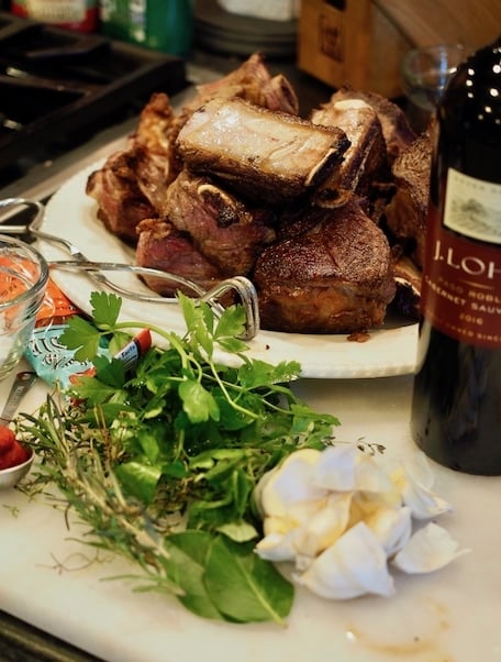 Short Ribs ingredients with red wine, herbs, garlic and browned short ribs.