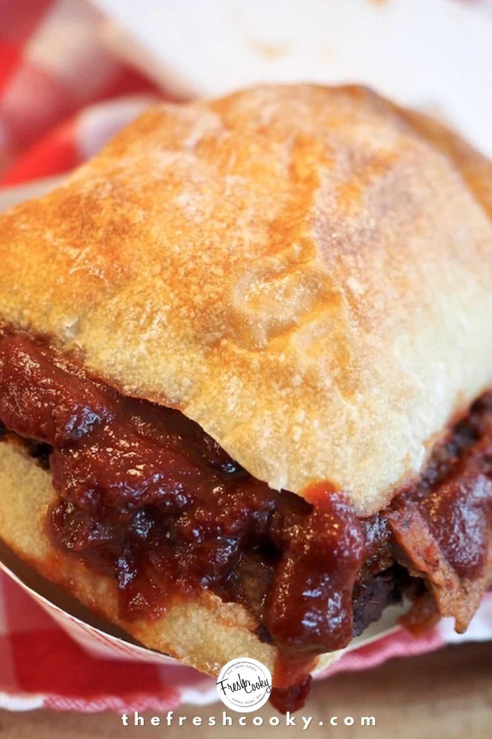Beef brisket with barbecue sauce on ciabatta roll. 