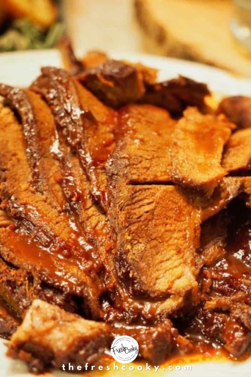 white plate of sliced barbecue beef brisket.