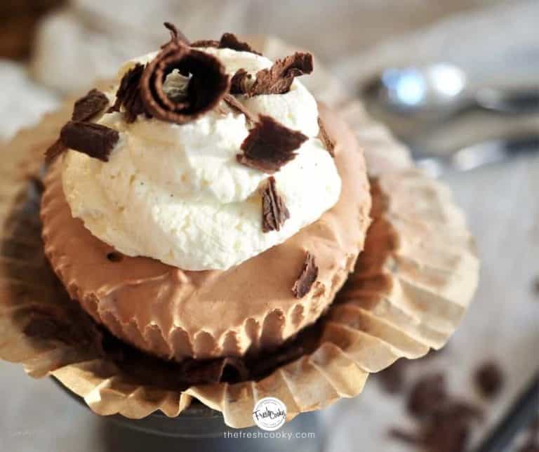 closeup of mini french silk chocolate pies with whipped cream and chocolate curls | #thefreshcooky