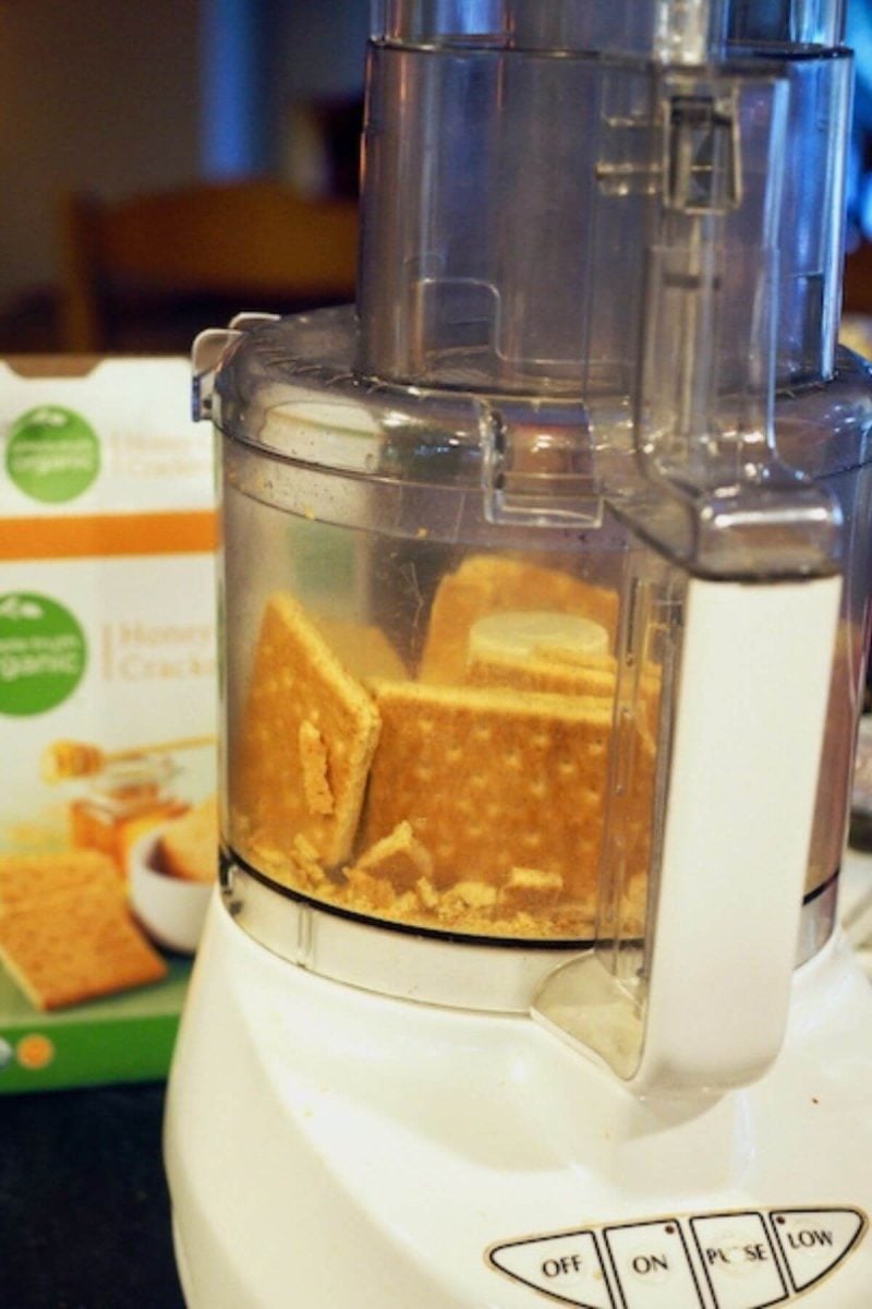 Lightly break up graham crackers and process into crumbs in food processor.