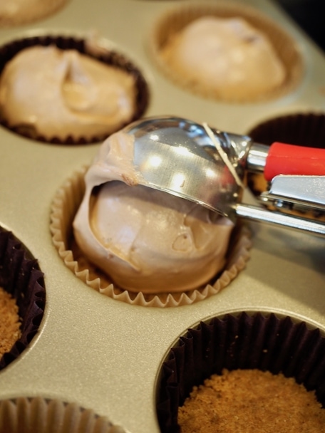 scooping the french silk mixture into muffin tins for Mini Chocolate French Silk Pies | www.thefreshcooky.com