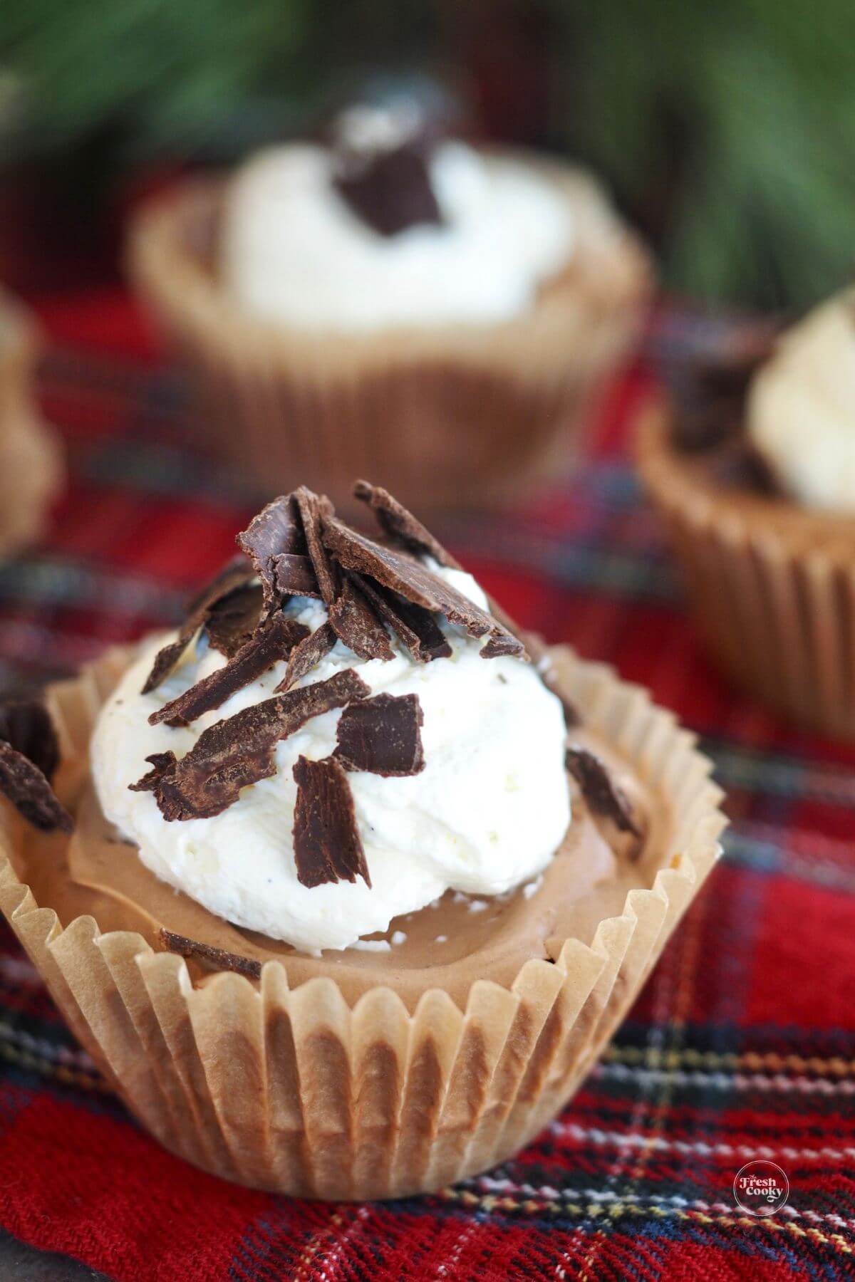 Mini chocolate pies in cupcake liners dressed up for Christmas.