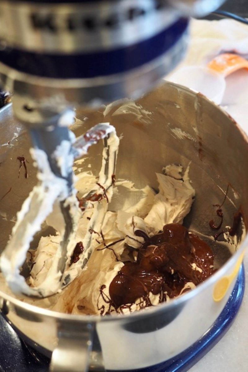 Beat in melted chocolate to whipped butter and sugar. 