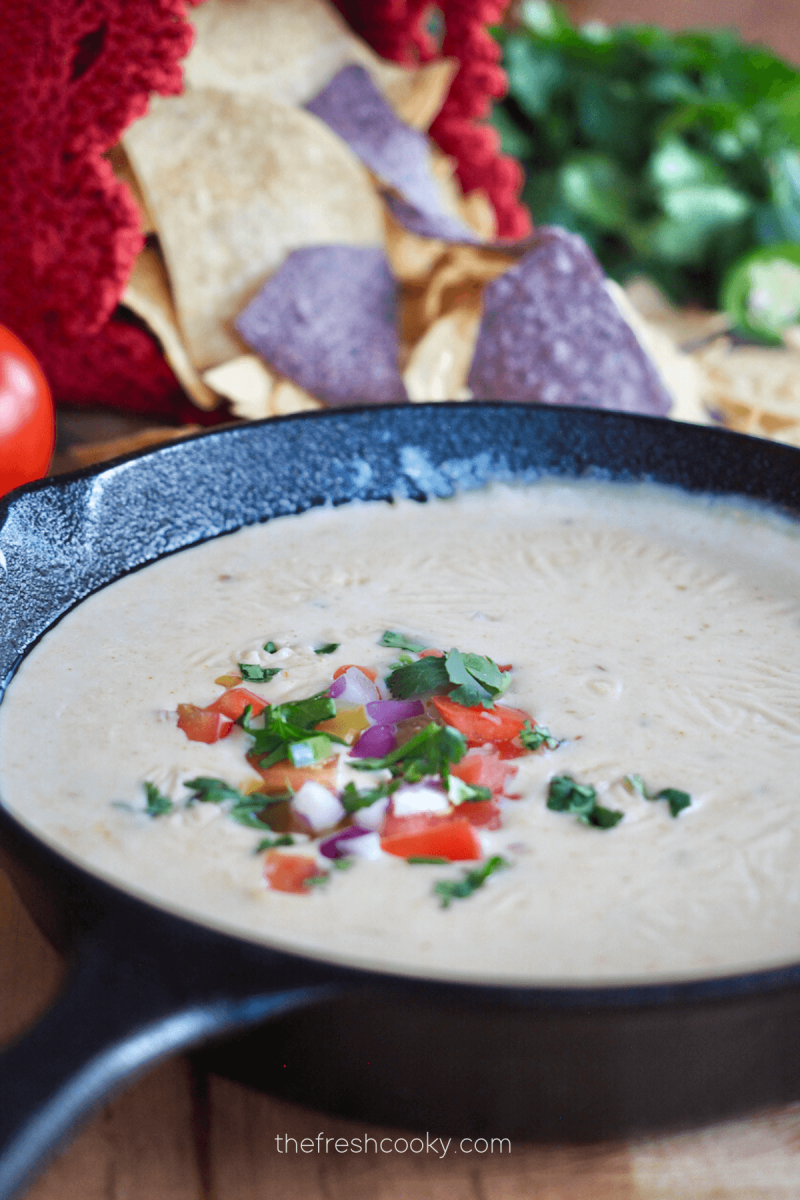 A cast iron pan filled with creamy Mexican White Cheese Queso dip. 