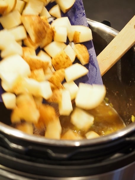 Pouring cubed russet potatoes into instant pot