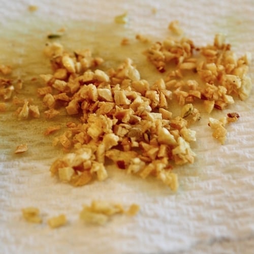 Toasted Garlic sitting on a paper towel for three cheese dips.