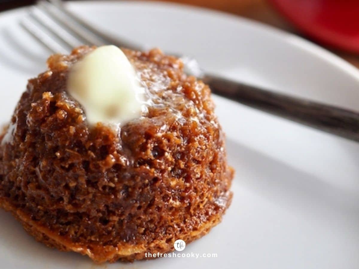 Mimi's Honey Bran Muffin with pat of melting butter and honey on white plate with fork nearby.